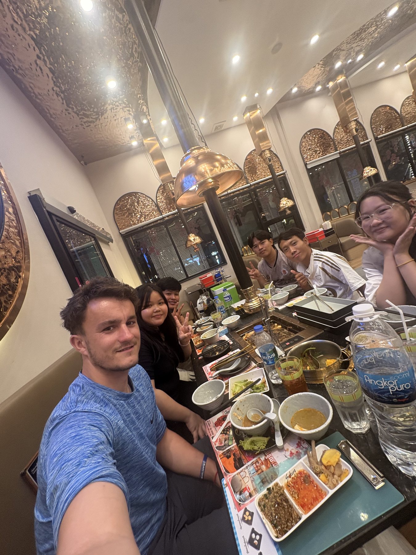 Ollie sharing a meal with young people in Cambodia